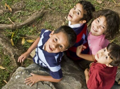 children standing at base of tree looking up. Playgroup Wentworthville